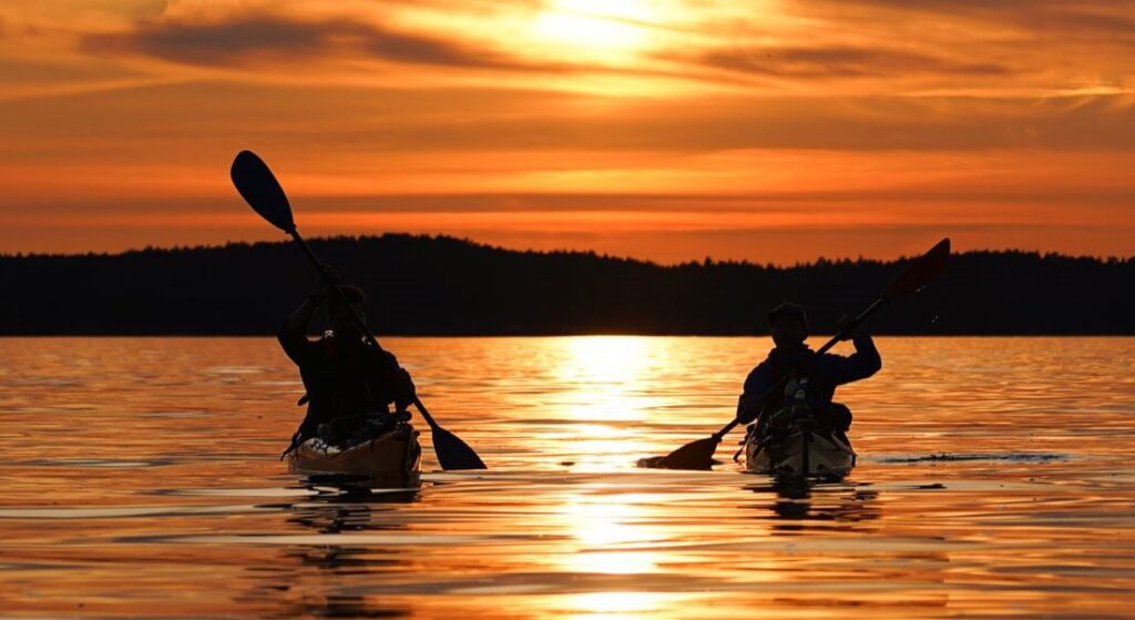 Kayakers watching the sunset in Finland