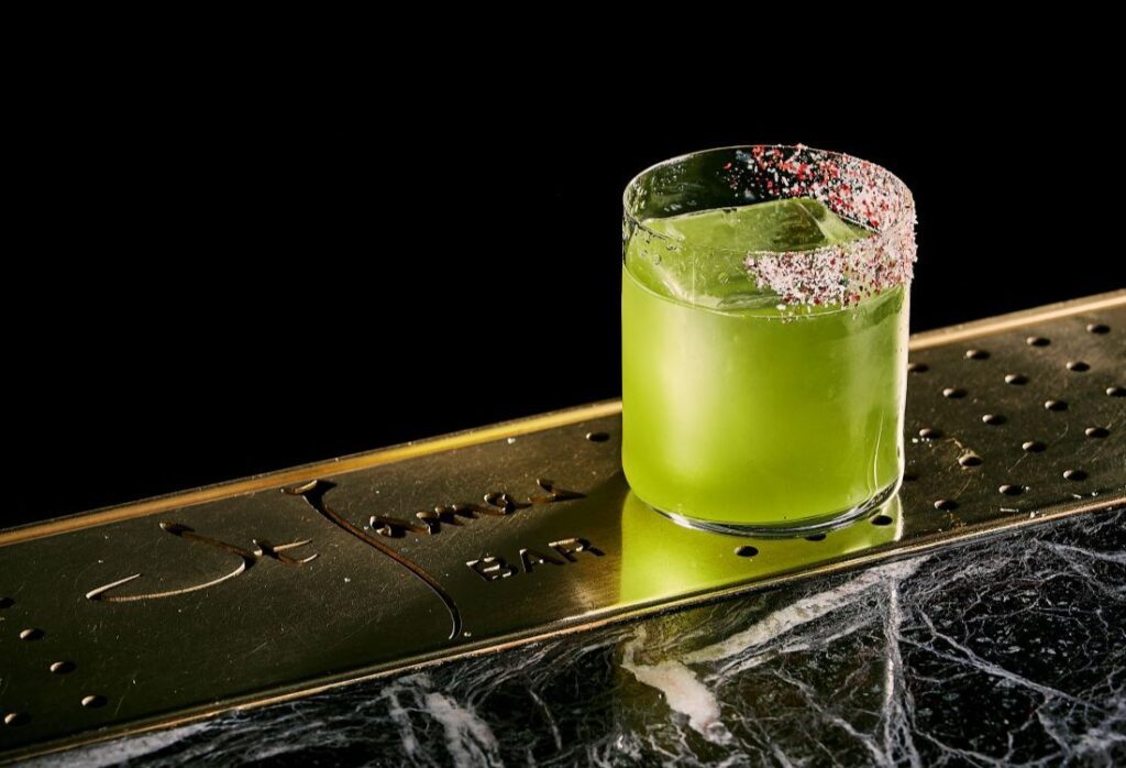 Green tequila cocktail on a bar