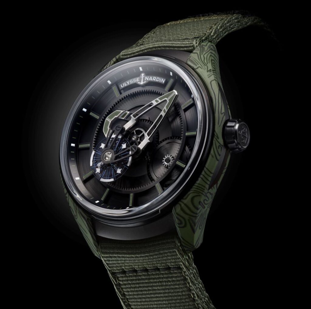 Image shows a khaki green and black watch against a black background